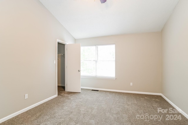 interior space with a closet, lofted ceiling, and carpet flooring