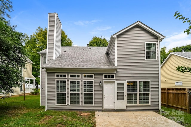 rear view of property with a patio and a yard