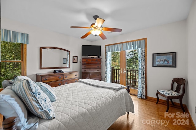 bedroom featuring light hardwood / wood-style flooring, access to exterior, and ceiling fan