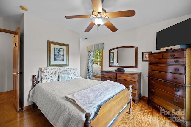 bedroom with wood-type flooring and ceiling fan