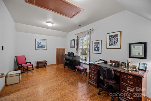 home office featuring vaulted ceiling and light wood-type flooring