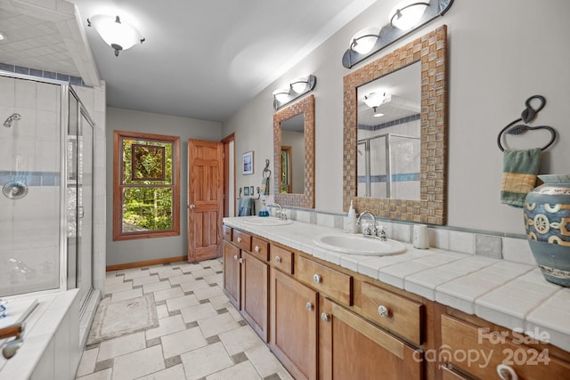 bathroom with vanity and a shower with shower door