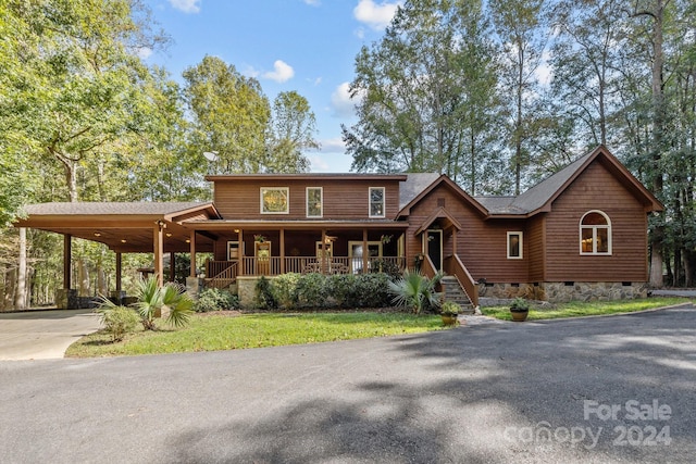 view of front of home with a carport and a porch