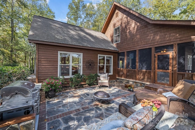 rear view of house with a patio and a sunroom