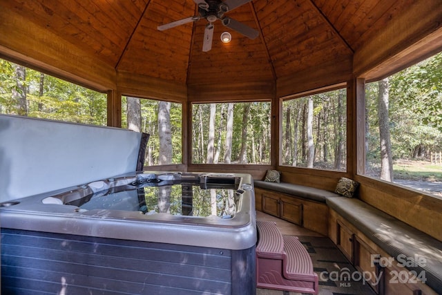 unfurnished sunroom featuring a hot tub, wooden ceiling, and vaulted ceiling