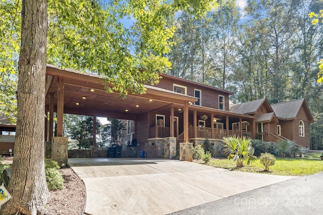 view of front of property featuring covered porch and a carport