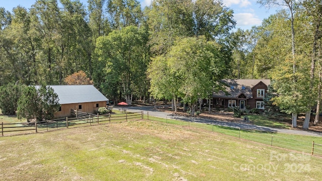 view of yard with an outbuilding and a rural view