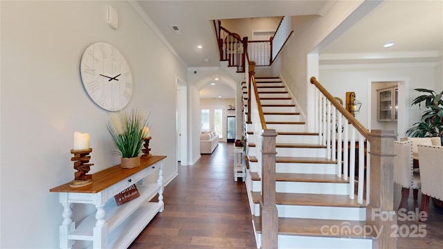 entrance foyer with crown molding and dark hardwood / wood-style floors