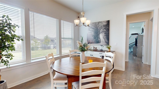 dining room with a chandelier, dark hardwood / wood-style flooring, and a healthy amount of sunlight