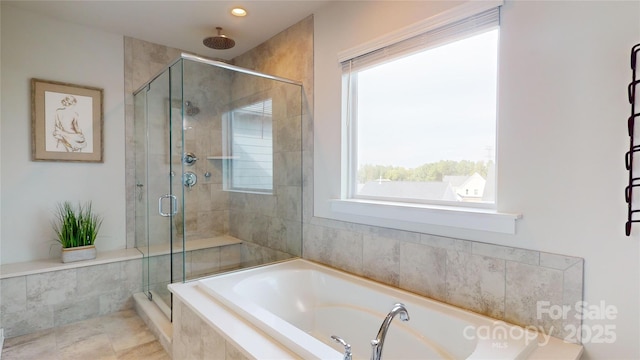 bathroom with separate shower and tub