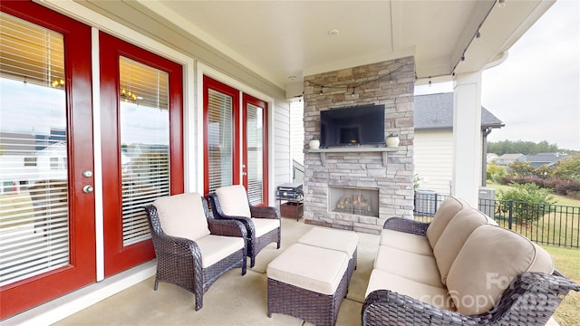 view of patio / terrace with an outdoor living space with a fireplace