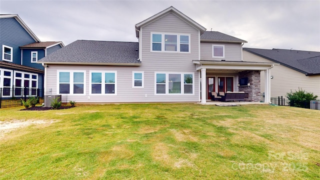 rear view of property featuring outdoor lounge area, a yard, a patio, and central AC unit