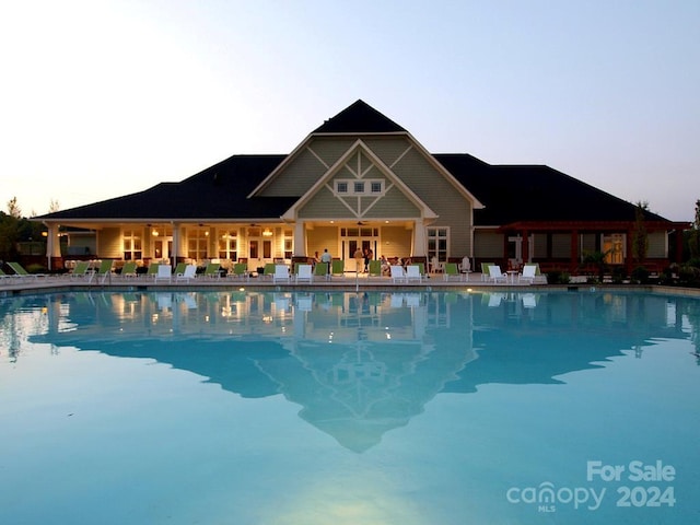 pool at dusk with a patio