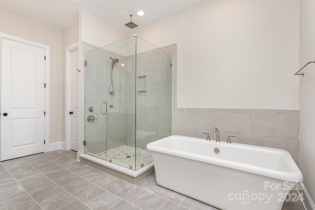 bathroom featuring shower with separate bathtub