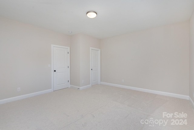 unfurnished room with light colored carpet