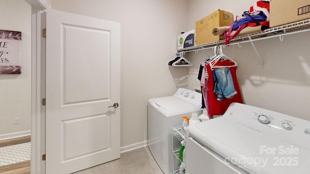 clothes washing area with washing machine and dryer