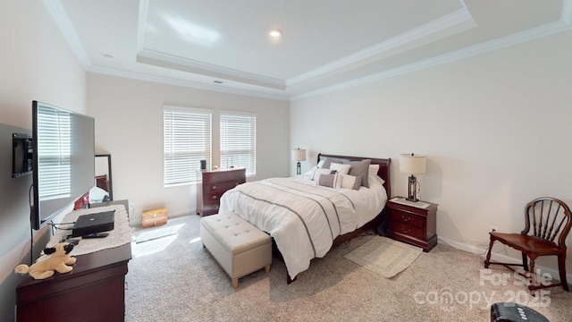 bedroom featuring light colored carpet, ornamental molding, and a tray ceiling