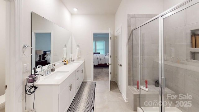 bathroom featuring tile patterned flooring, vanity, and a shower with shower door