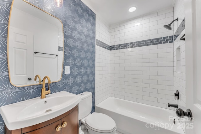 full bath with  shower combination, vanity, toilet, and wallpapered walls