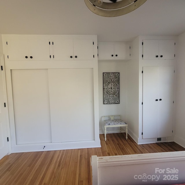 mudroom featuring light wood finished floors and visible vents