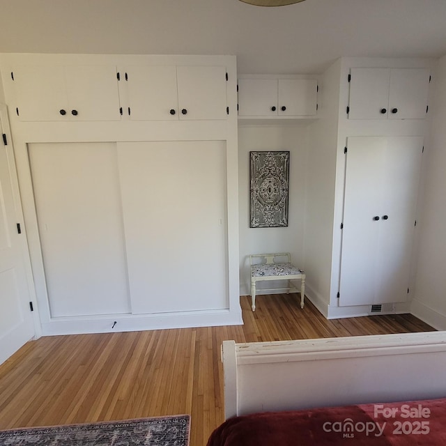 mudroom featuring light wood-style flooring and baseboards