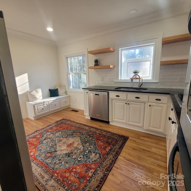 kitchen with a sink, white cabinetry, dishwasher, open shelves, and dark countertops