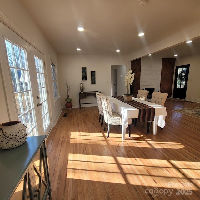 interior space featuring baseboards, french doors, light wood-style flooring, and recessed lighting