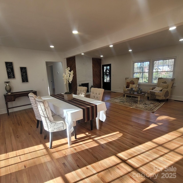 interior space with light wood-style floors, a fireplace, and recessed lighting