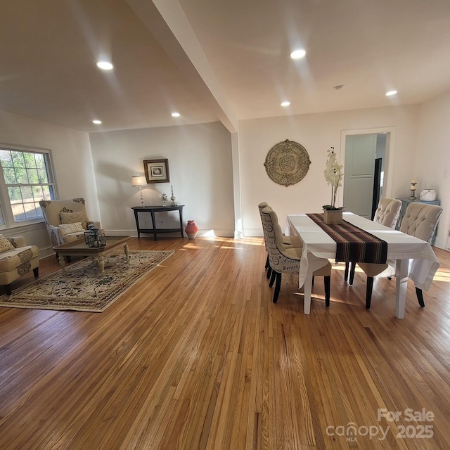 dining room featuring baseboards, light wood-type flooring, and recessed lighting