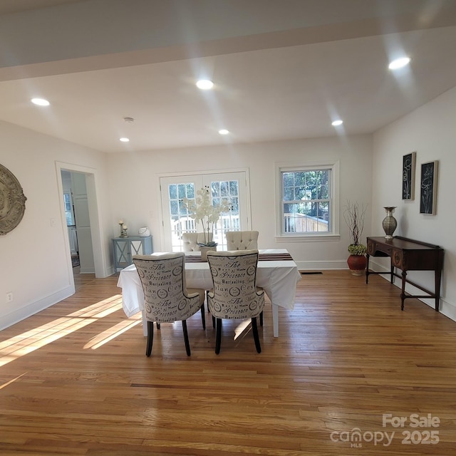 dining space featuring recessed lighting, a healthy amount of sunlight, baseboards, and wood finished floors