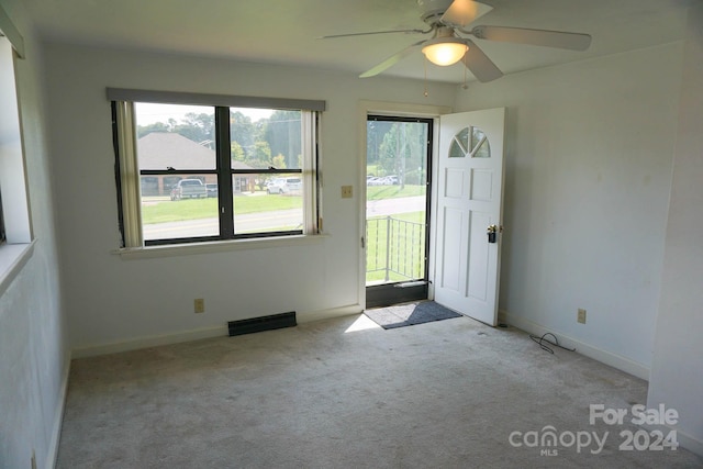 carpeted empty room featuring ceiling fan