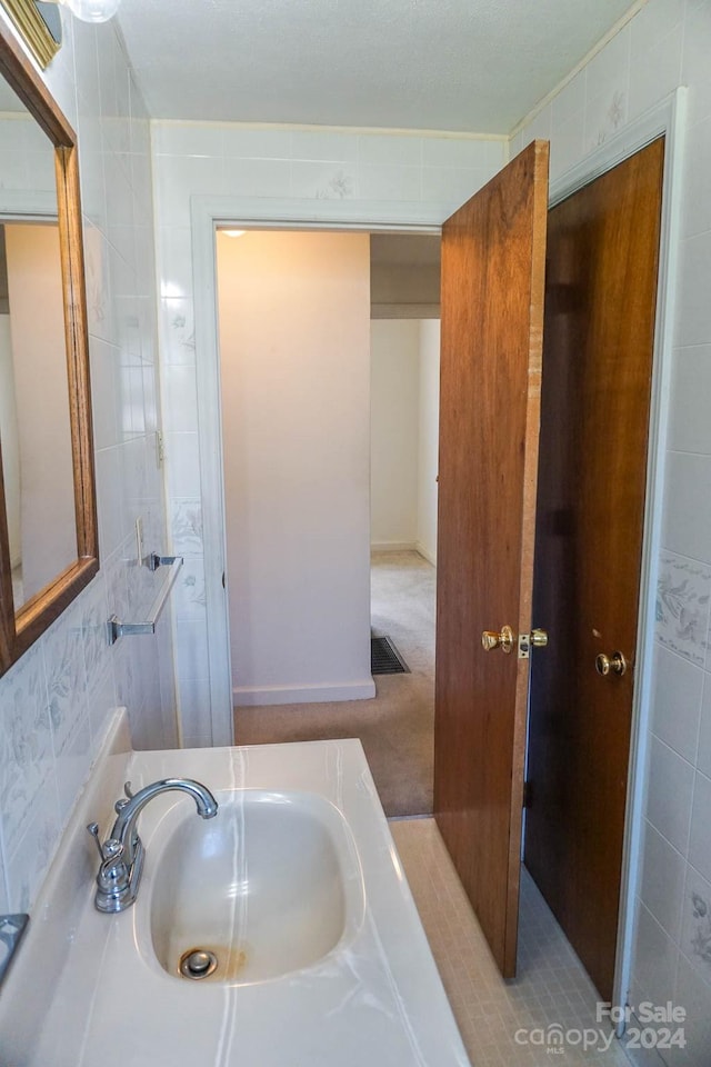 bathroom with tile walls and vanity