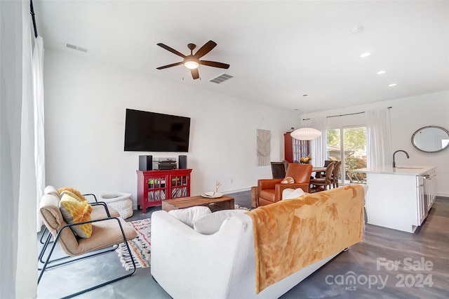 living room with ceiling fan, sink, and dark hardwood / wood-style flooring