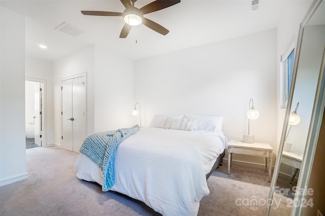 carpeted bedroom featuring a closet and ceiling fan