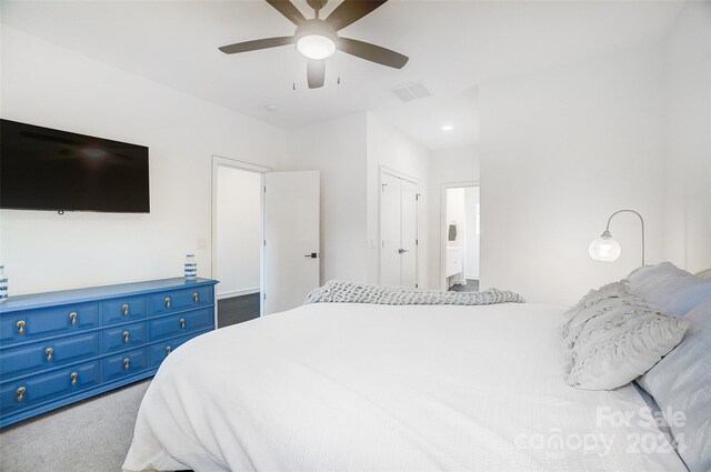 carpeted bedroom with ceiling fan and a closet