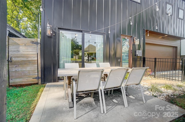 view of patio featuring outdoor dining area and fence