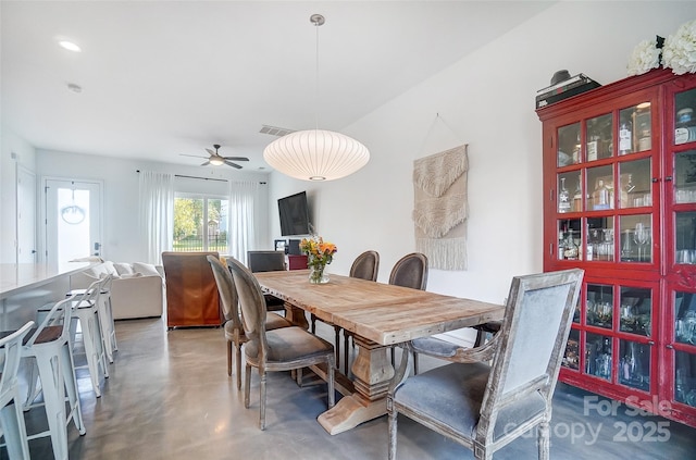 dining space featuring concrete flooring, visible vents, and ceiling fan