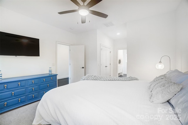 carpeted bedroom with visible vents and ceiling fan