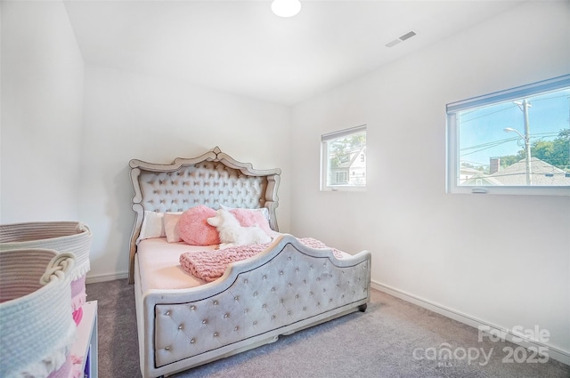 bedroom with carpet, visible vents, and baseboards