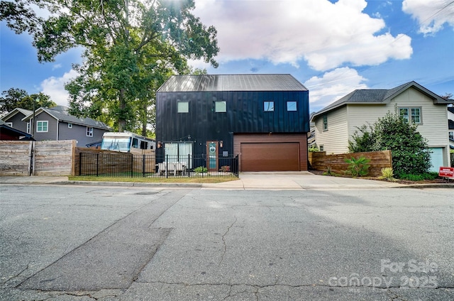 view of front of property featuring a garage and a fenced front yard