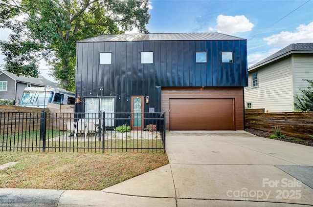 view of front of property with a fenced front yard and concrete driveway