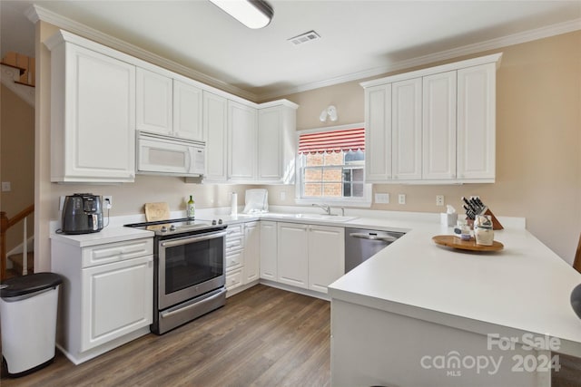 kitchen featuring ornamental molding, sink, dark wood-type flooring, white cabinetry, and stainless steel appliances