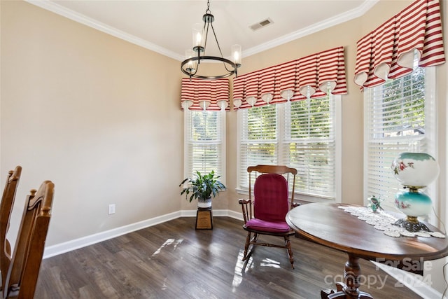 sitting room with ornamental molding, a chandelier, and dark hardwood / wood-style flooring