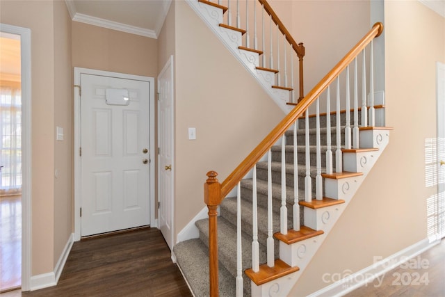 entrance foyer featuring ornamental molding and dark wood-type flooring