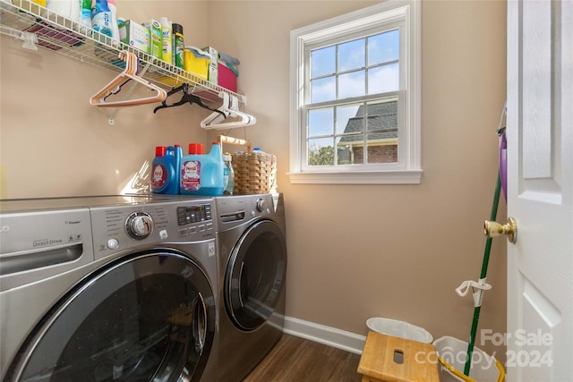 laundry room with washer and clothes dryer and dark wood-type flooring