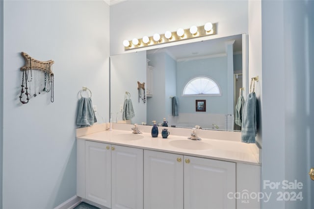 bathroom with ornamental molding and vanity