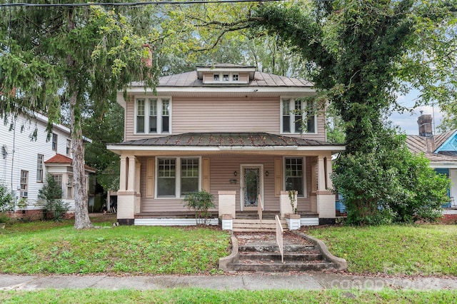 view of front facade featuring a front lawn and covered porch