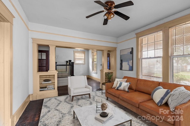 living room with wood-type flooring, ceiling fan, and ornate columns