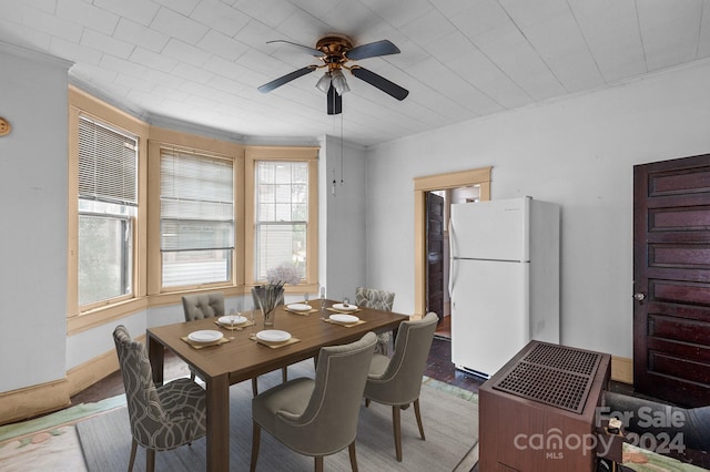 dining space with ornamental molding, ceiling fan, and hardwood / wood-style floors