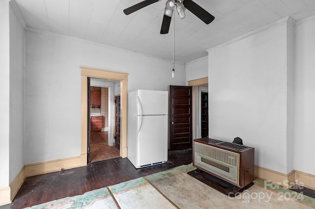 interior space with ornamental molding, ceiling fan, dark hardwood / wood-style floors, and white fridge